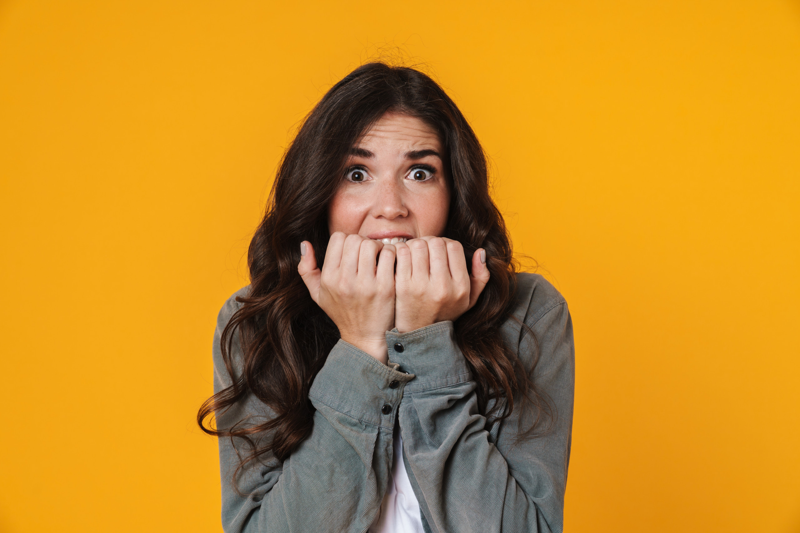 Scared beautiful girl posing and looking at camera